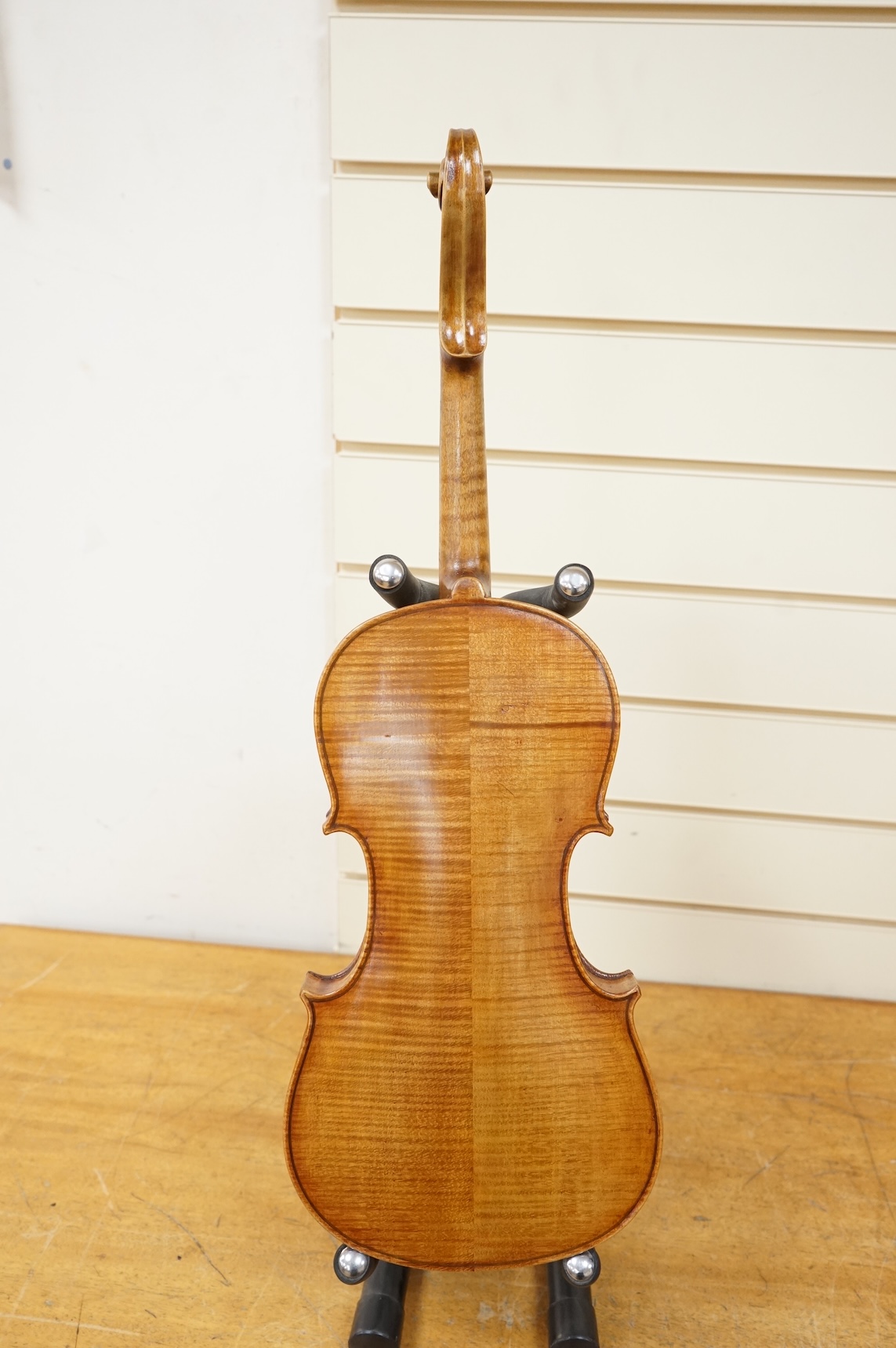 Three cased violins; a German Dresden violin, supplied by Campbell and co., Glasgow, together with another Dresden Stradivarius copy, and the remains of a European violin.
